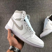 Single white and grey high-top sneaker held at an angled side view.