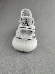 Front view showing the rounded toe, patterned knit upper, laces, and translucent sole.