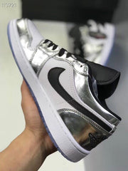 Side view of the sneaker showing silver overlays, a white quarter panel and black side panel.