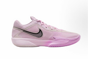 Side view of a pink Nike G.T Cut Cross EP sneaker with a dark Swoosh outline, perforated upper, and pink outsole.