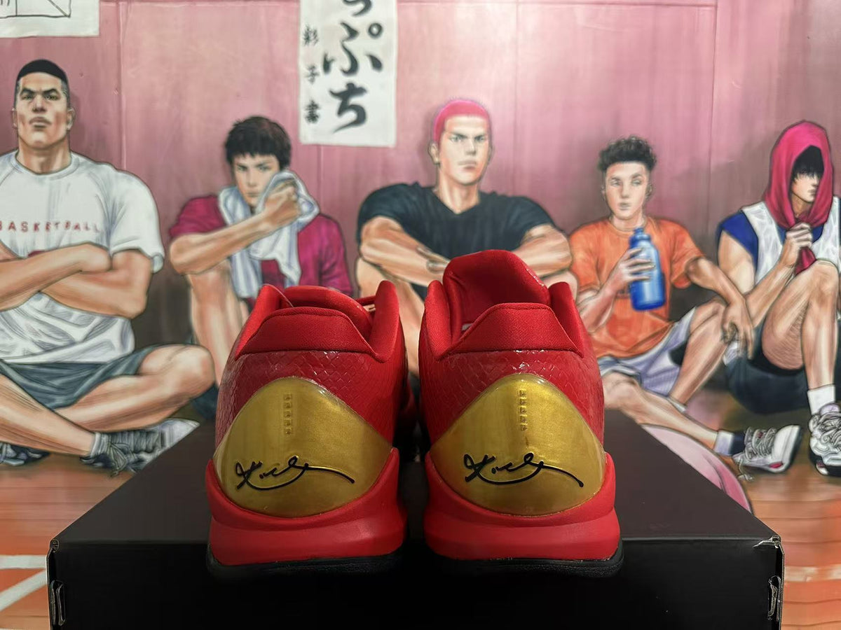 Rear view of red basketball shoes with gold heel panels