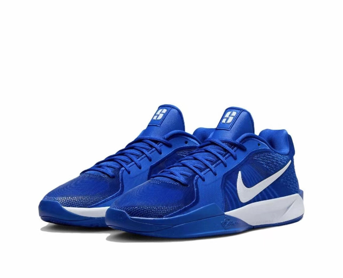 Pair of blue Nike basketball sneakers with white Swoosh logos and white midsole sections on a white background.