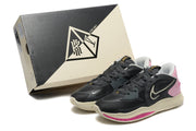 Charcoal and pink Nike Kyrie shoes beside a Kyrie Low 5 shoe box