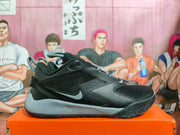 Side view of black Nike basketball shoes with grey Swoosh, laces, and midsole