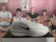 Side view of a grey Nike sneaker showing the black swoosh detail, laces, and sculpted sole.