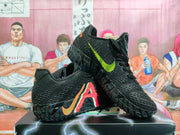 Pair of black Nike basketball sneakers with red, orange and lime accents shown from an angled side view.