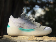 Side profile showing the patterned lavender upper, gray overlays, and teal accent strip.