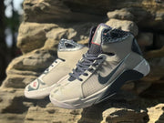 Angled front view of the gray and black lace-up sneakers with patterned collars and dark laces.
