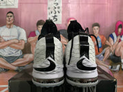 Rear view showing black Nike Swoosh branding, black heel overlays, and translucent outsole sections.
