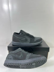 Side and outsole views of dark grey and black Air Jordan 1 Low sneakers