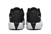 Rear view of the black sneaker pair showing white midsoles, textured outsoles, and purple accents.