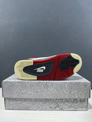 Bottom view showing the sneaker outsole with red, dark navy, cream, and herringbone traction sections.