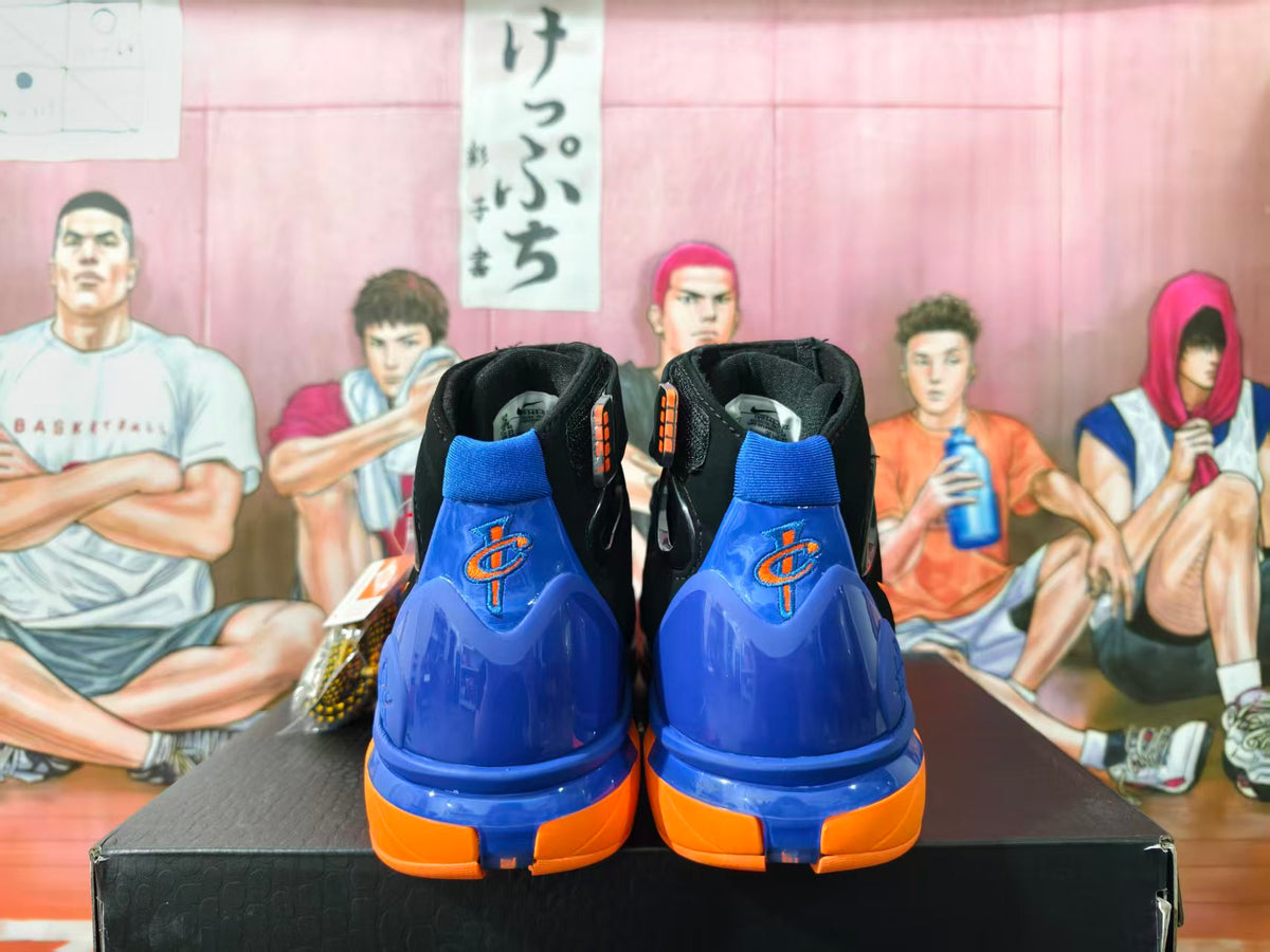 Rear view of black Nike Air Huarache 2K4 high-top shoes with blue and orange heel accents