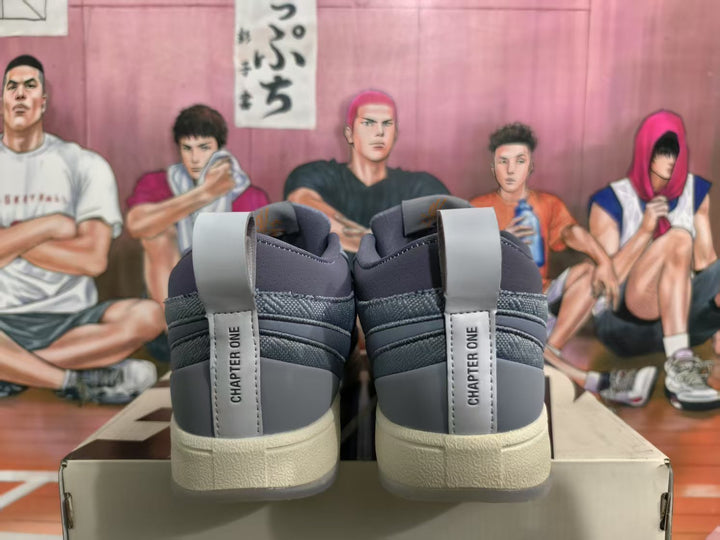 Rear view of gray Nike sneakers showing Chapter One heel detailing, off-white midsoles, and a translucent outsole section.