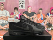 Side profile of a black Nike basketball shoe with tonal Swoosh branding