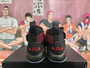 Rear view showing Nike LeBron branding, black textured heels, red accents, and light-colored outsoles.