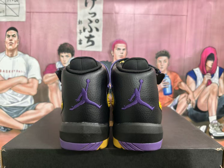 Rear view of black high-top basketball sneakers with purple Jumpman logos and purple outsole accents.