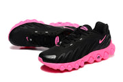 Three-quarter view of black lace-up sneakers with pink accents and sculpted soles