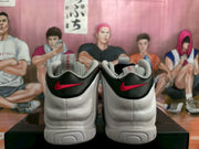 Rear view showing black heel panels, red Swoosh details and white midsoles.