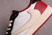 Close-up of the cream Swoosh, white side panel, red heel panel, and textured cream midsole.