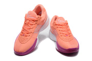 Pair of coral Nike basketball sneakers shown from the front, with purple outsole accents and white side details.