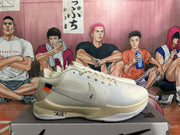 Side profile of a white Nike basketball sneaker showing the swoosh, contrast heel accent, perforated paneling and printed midsole text.