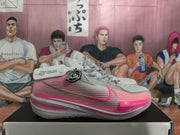 Grey and pink Nike basketball shoe shown from the side