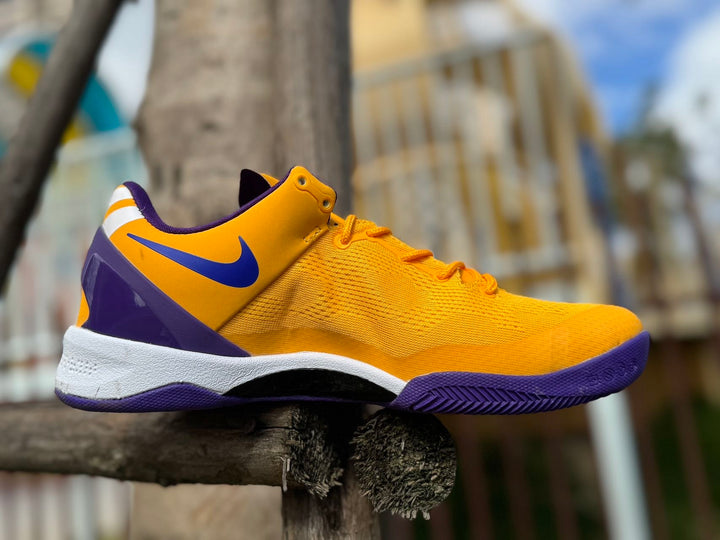 Side view of a gold and purple Nike Kobe 8 basketball shoe