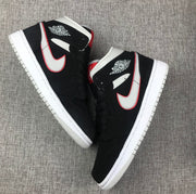 Top-down view of the pair showing black uppers, silver side panels and red accents.