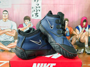 Angled view of the black and blue Nike Air Destrukt high-top sneakers with white Swoosh logos.