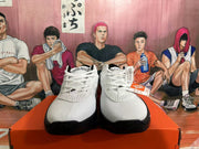Front view of white Nike basketball shoes with black soles