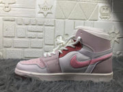 Side view highlighting the pink Swoosh, layered panels, and padded ankle collar.