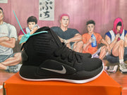 Side view of a black Nike Hyperdunk shoe with a silver Swoosh
