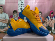 Angled view of the yellow and blue sneakers