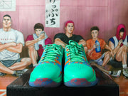 Front view of the pair showing perforated toe panels, patterned laces, and colorful splatter detailing.