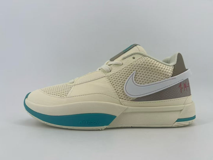 Side view of cream Nike basketball shoes with mesh panels, a contrasting Swoosh, and teal outsole accents