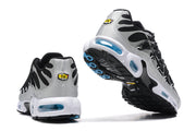 Nike Air Max Plus sneakers shown from the heel and outsole, with blue accents and visible cushioning