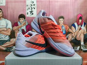 Two coral and lavender Nike basketball shoes shown from side and angled front views.