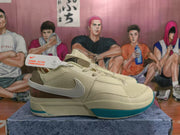Side profile of a Nike basketball sneaker showing the Swoosh, mesh side panel, layered midsole, and teal outsole accent.