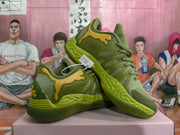 Angled view of green lace-up basketball sneakers with yellow side accents