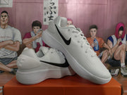 Angled view of the white sneakers highlighting the black Swoosh, padded collar, and textured outsole.