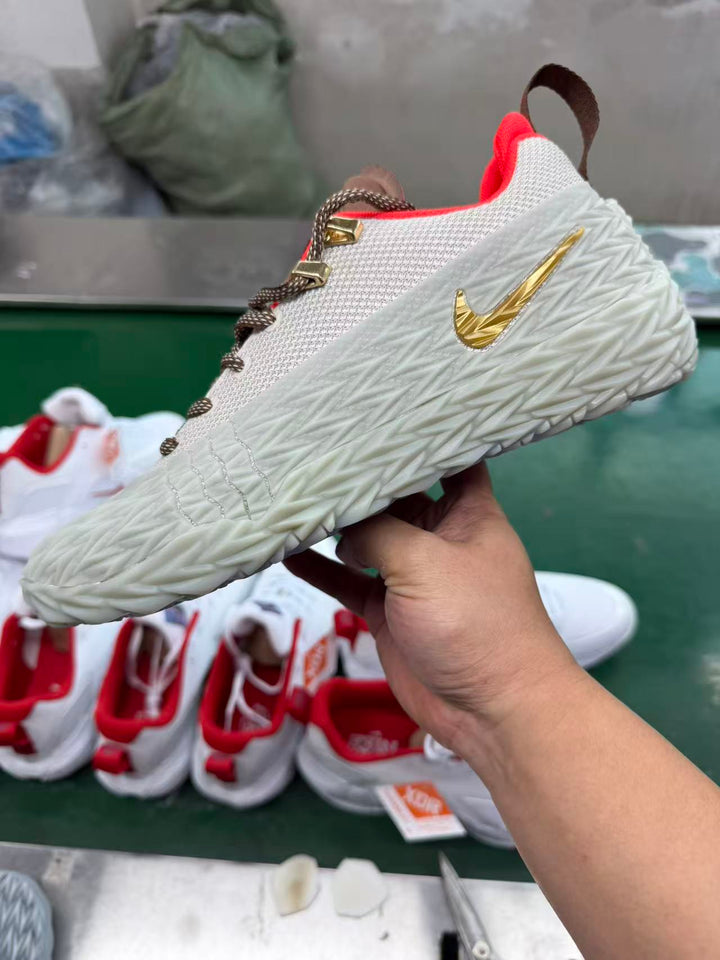 Nike S.T. Charge sneaker in khaki with a white textured upper, gold-tone Swoosh and sculpted white midsole.