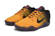 Pair of orange and black low-cut basketball shoes, front three-quarter view