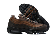 Side profile and outsole view of brown Nike Air Max 95 TT sneakers.