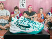 Side view showing the lake-green Nike swoosh, numeric-style upper pattern, white midsole, and green outsole.
