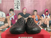 Front view of black Nike sneakers showing the ventilation openings and textured forefoot.