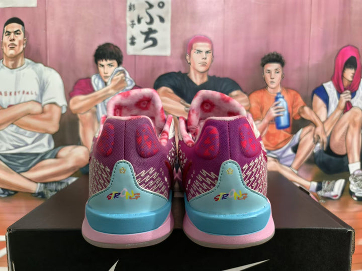 Rear view of purple, pink, and blue Nike basketball shoes with patterned panels and colorful heel details.