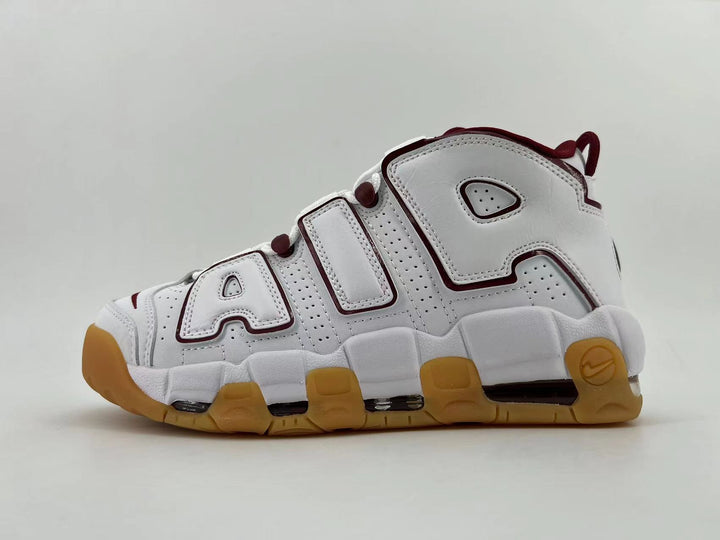 Side view of white Nike AIR sneakers with burgundy trim and a gum-colored outsole.