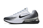 Side view of a white Nike sneaker with black dotted accents, a black Swoosh, and a visible heel unit.