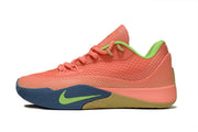 Side view of coral Nike S.T. Flare EP basketball shoes with green accents and dark blue outsoles.